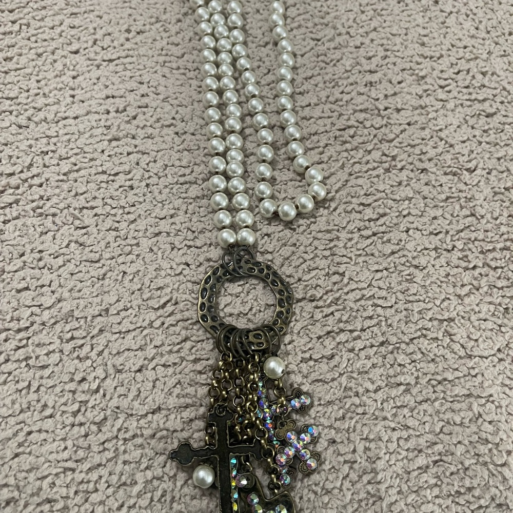 Star Bar cross necklace with iridescent stones.